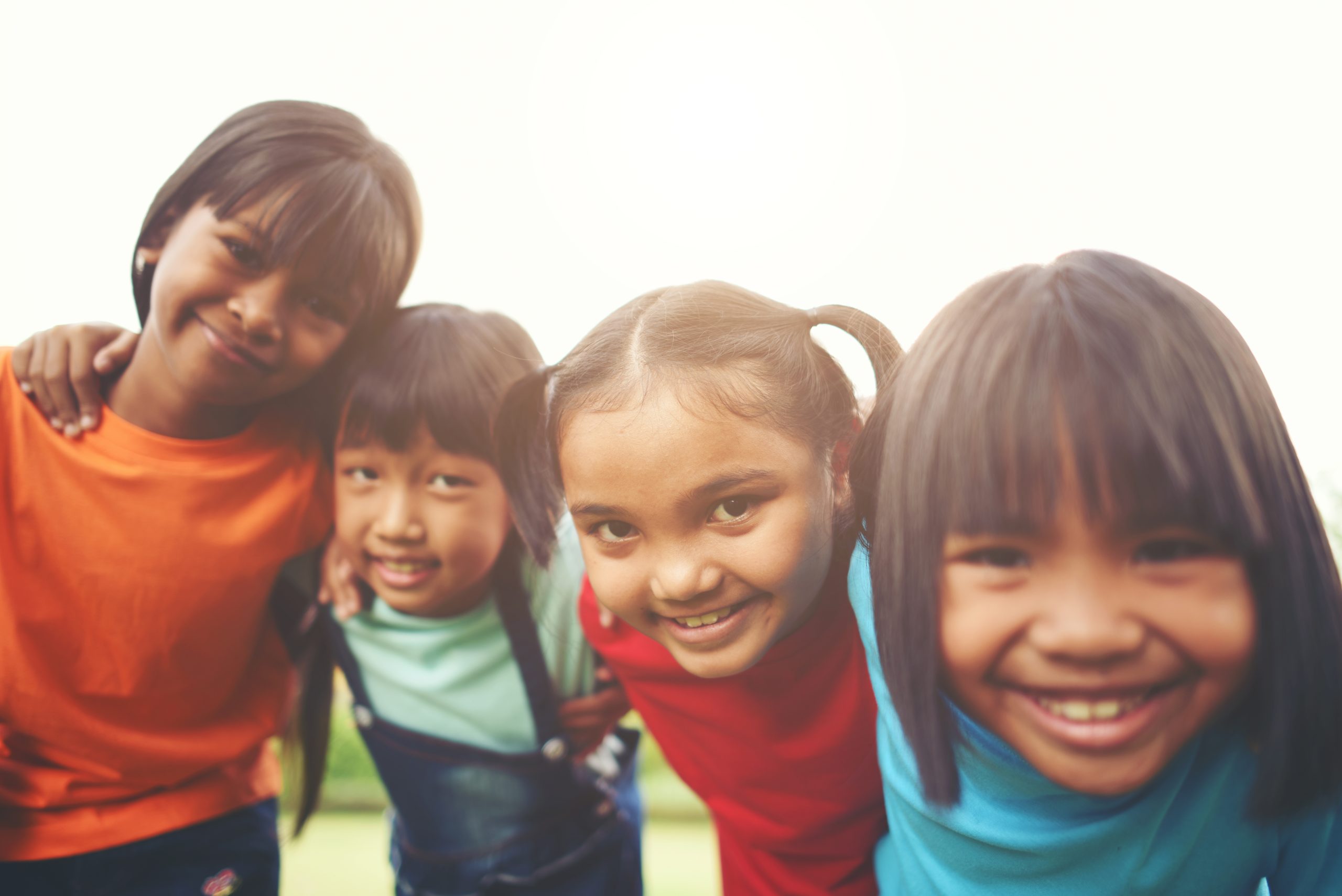 Close up of girl child friends in a park smiling to camera